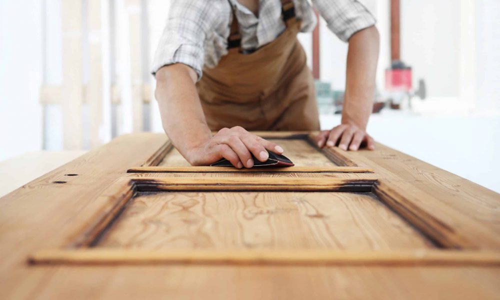 carpenter work the wood with the sandpaper carpenter work the wood with the sandpaper